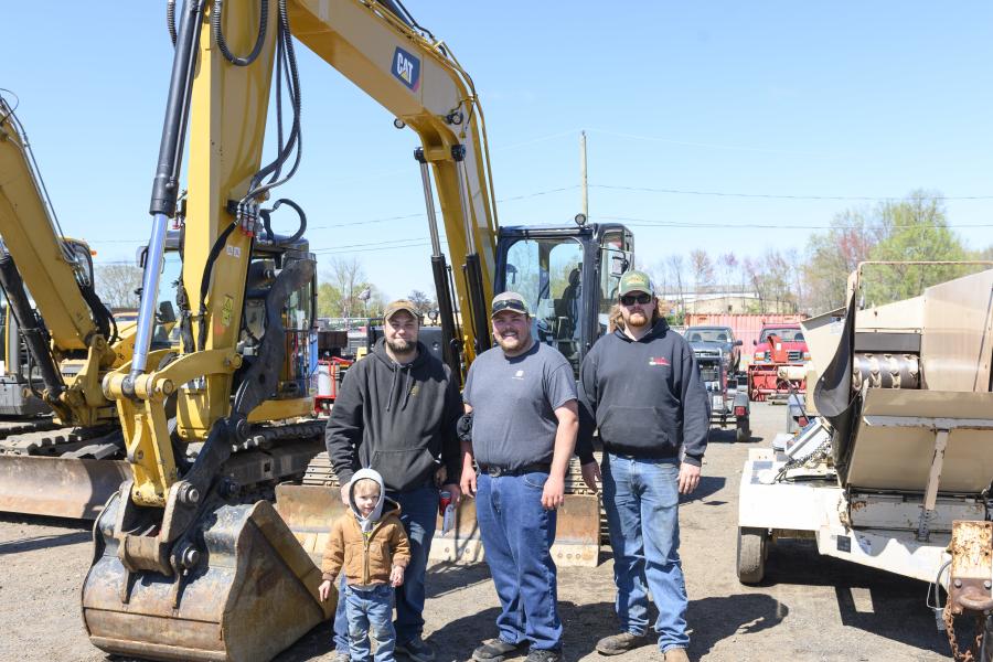 (L-R): Mark Swiatowiec Jr. with son, Mark III, of Cedar Ridge Construction in Newington, Conn.; John Vessel of JV3 Construction, Rocky Hill, Conn.; and Joe Viello of New England Blacktop, Glastonbury, Conn., stand in front of the 2020 Caterpillar 310 hydraulic excavator, one of the biggest ticket items of the weekend.
