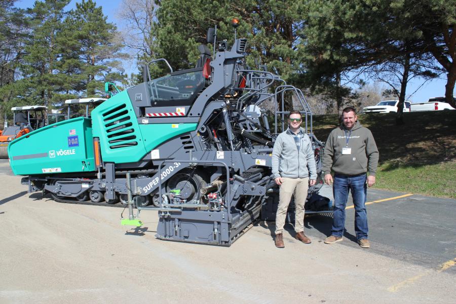 (L-R): Brandon Brever (L), associate director of the Minnesota Asphalt Pavement Association, St. Paul, Minn., with Hayden Murphy’s Phil Laumann, technical service specialist, Bloomington, Minn., and a Vogele Super 2000-3i. The tracked paver is designed primarily for use in highway construction and large-scale commercial applications.
