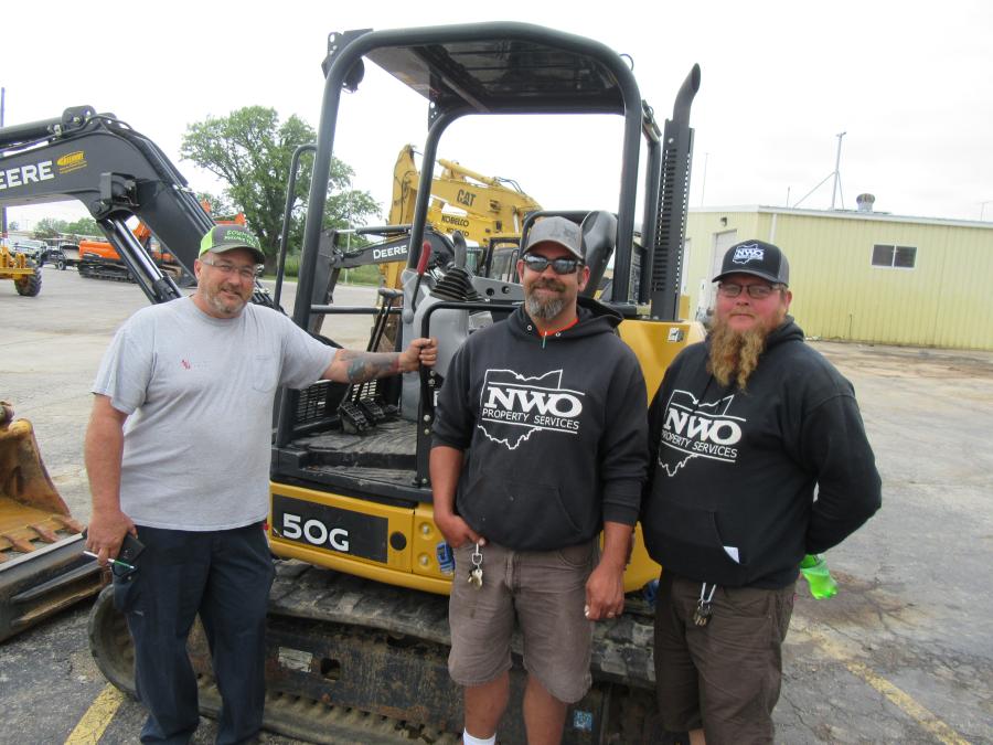 (L-R): While waiting for the skid steer attachments to go on the block, Mack Bowman of Bowman Pulling Team spoke with Frank Schneider and Brandon McCoy of NWO Property Services.
