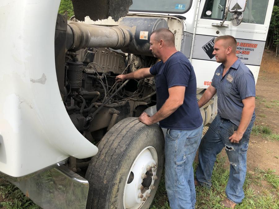 John and Luke Earles, both of JSE Excavating in Martinsville, Va., inspect this Peterbilt road tractor.