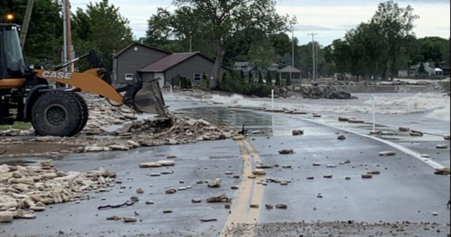 A crew from the Ohio Department of Transportation in Ottawa County uses a front-end loader to clear debris from State Route 163 in Marblehead. The route and four others were closed due to flooding and debris on the roadways following a storm on May 28.