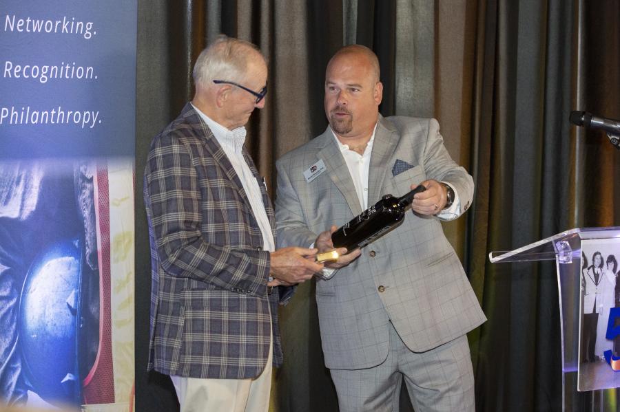 Retiring UCAC Board Member Skip Wilson, Core & Main, was surprised with a plaque and bottle of wine from UCAC's Immediate Past President Kevin Plourde, D & G Contractors.