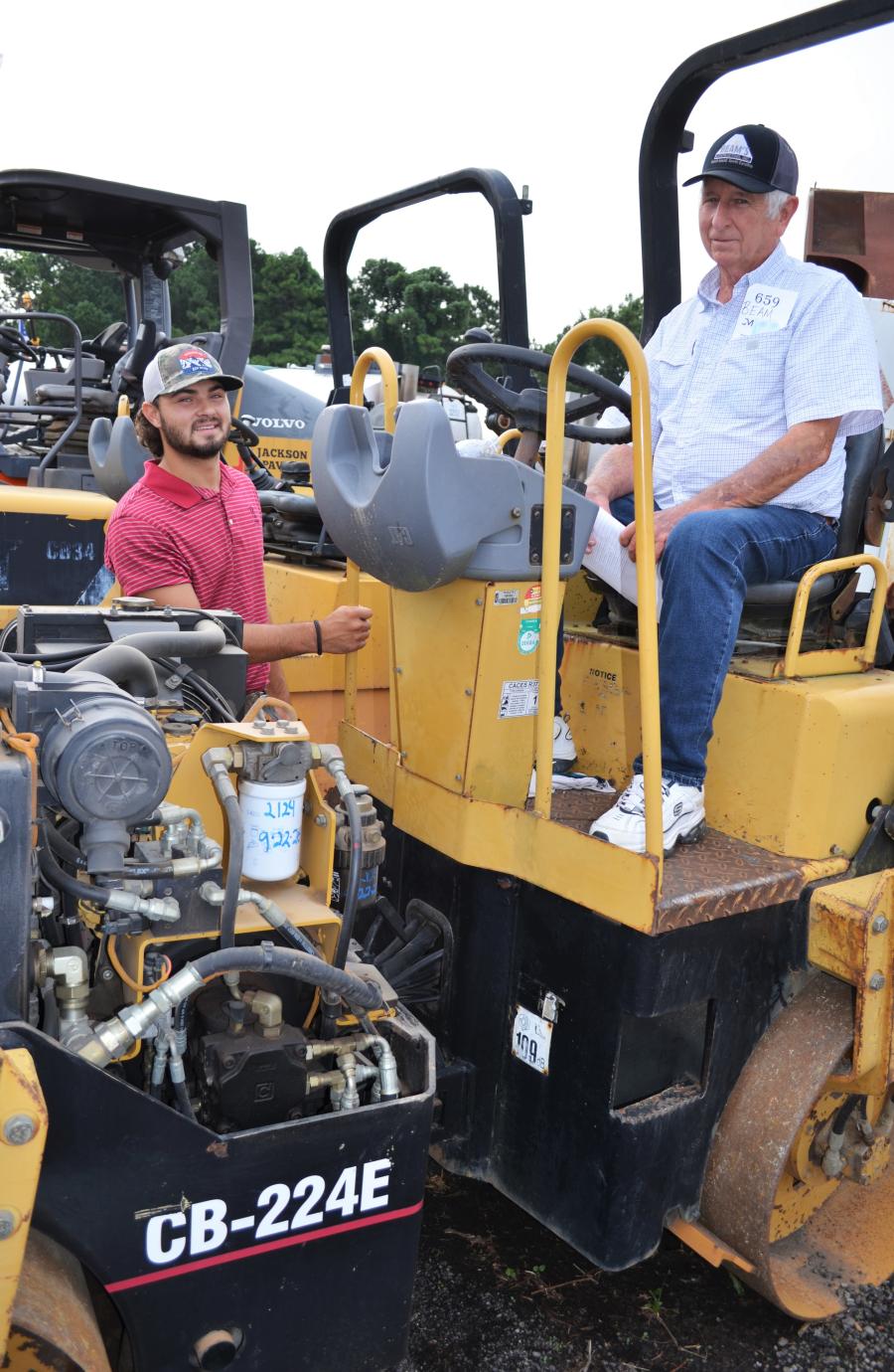 Nathan McGhee (L) and his grandfather, Johnny Beam of Beam’s Contracting, Augusta, Ga., inspect a Cat CB-224E compactor of interest.