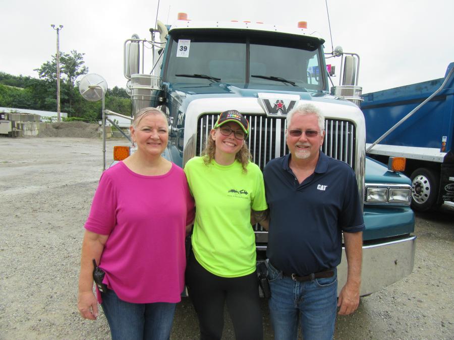 (L-R): Laura Wright with daughter, Jaclyn, and husband, Jim, owner of J & J Elite Transportation, kept an eye on the bidding while catching up with attendees at the auction.
