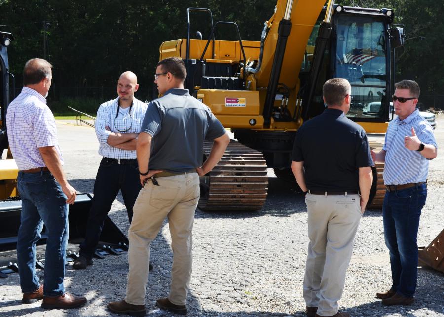 Customers and Yancey representatives take the opportunity to meet and talk about some of the Cat machines on display. 
