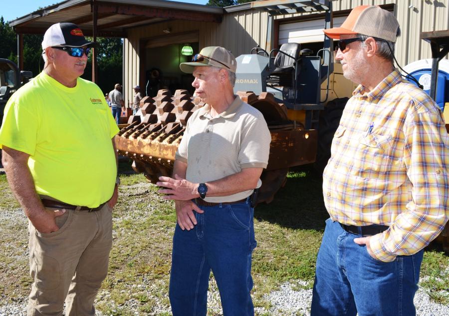 Discussing the machine lineup (L-R) are Timmy Shelnutt, Anderson Grading & Pipeline, Loganville, Ga; and Jerry Morris and Allen Dobbs, both of CA Murren & Sons, Grayson, Ga.   
