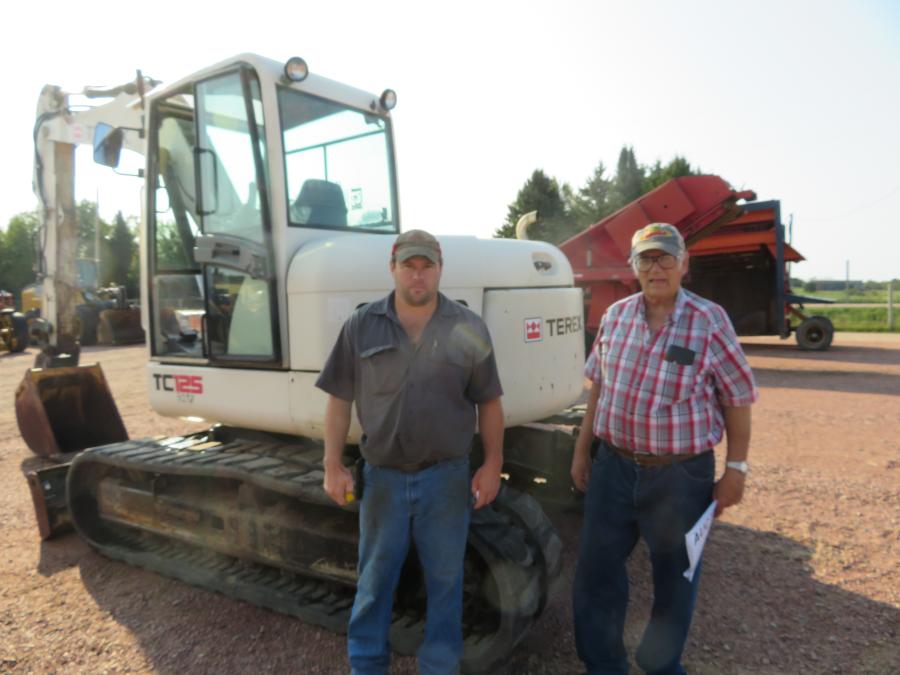 The father-and-son-team of Tim (L) and Lyle Brewer have a look at this Terex TC125 excavator.
