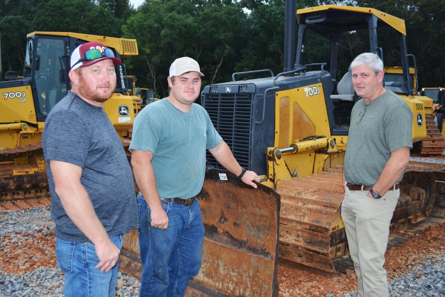 Heath Pate of Randolph, Ala., was looking over some of the Deere dozers about to go on the auction block with Taylon Simpson and Clint Cummings, of Colona Farms, Jemison, Ala.   
