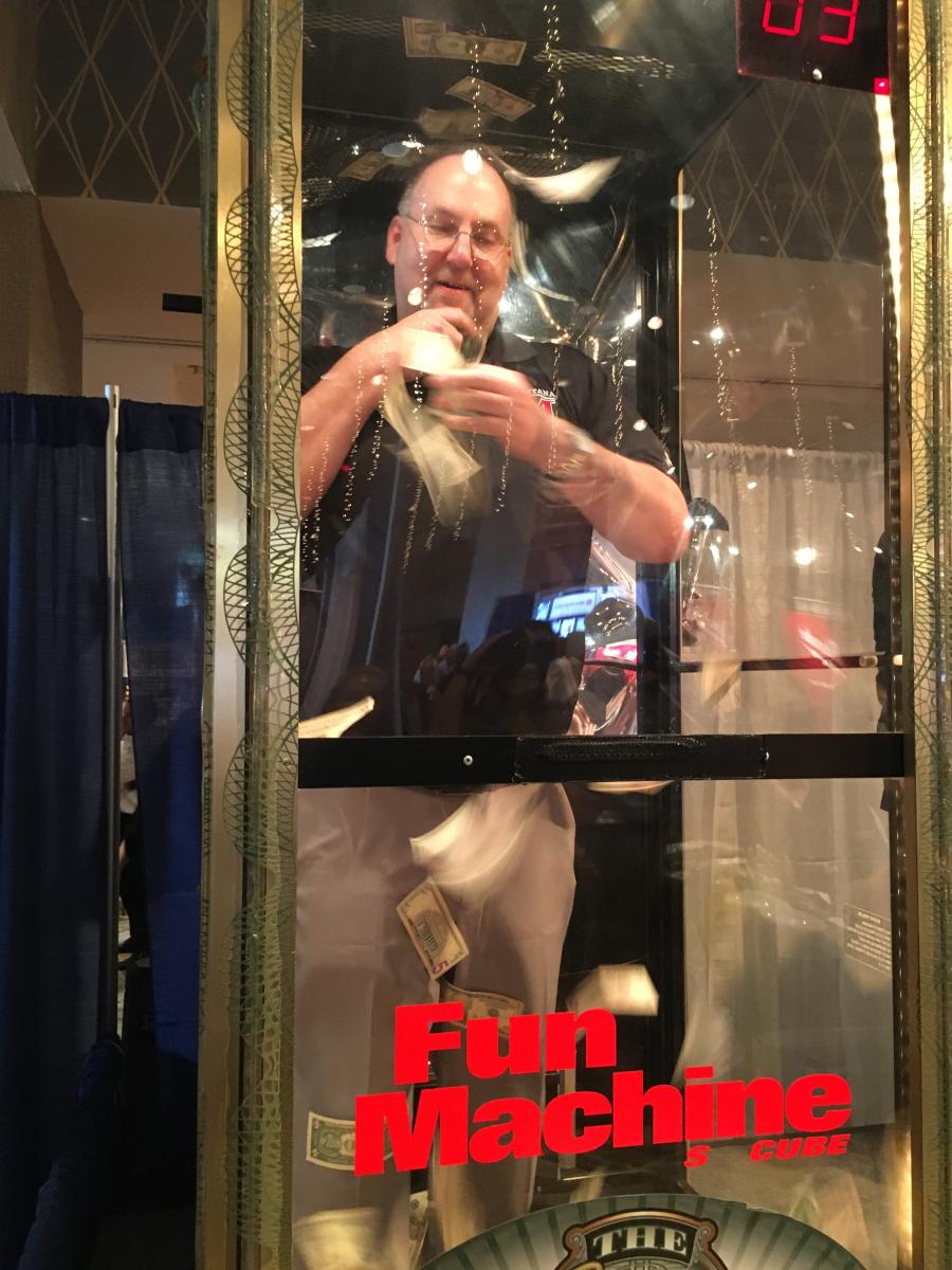 Eric Porter of Montana Construction Corp. tries his luck in The Kennedy Companies Fun Machine. He had 30 seconds to capture as much cash as he could. When his time was up, he scooped up $49.
