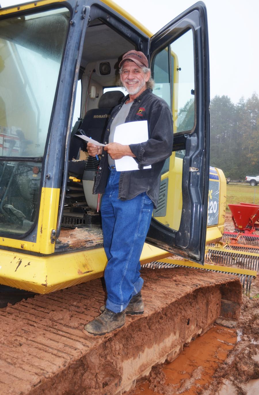 Wrapping up an inspection of a Komatsu PC220LC is Lonnie Underwood of Underwood Contracting Inc., Robbinsville, N.C.   
