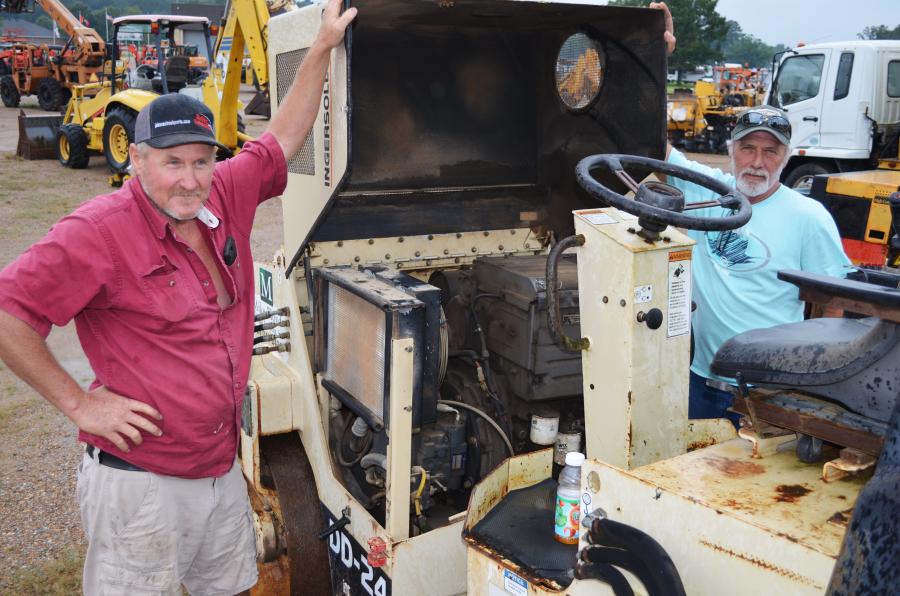 Opening up this Ingersoll Rand DD24 compactor for a careful inspection are paving contractors Randy Barnes (L) and David Weeks, both of Barnes Construction, Belzoni, Miss.  
