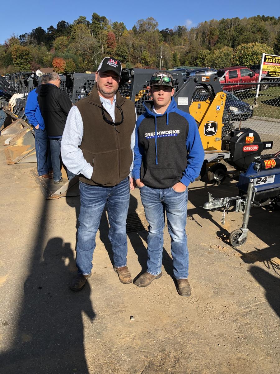 Jackie Atkinson (L) of J&J Truck Sales in Chatham, Va., and his son, Trey, who goes to Tunstall High School in Dry Fork, Va., look over the machines.