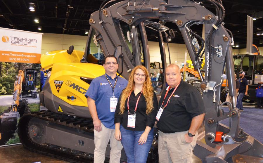 Displaying a Case skid steer in their exhibit area and one of the unique Mecalac machines (in background) from Trekker Tractor (L-R) are Michael Cabrera, Mandy Cardenas and Tony Yanes.