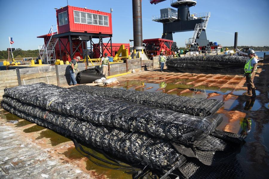 A smaller barge holds stone filled marine mattresses, which are lowered one at a time to the bottom of Raritan Bay. Each mattress is 22 ft. long. (Nathan Kensinger, WNYC/Gothamist photo)