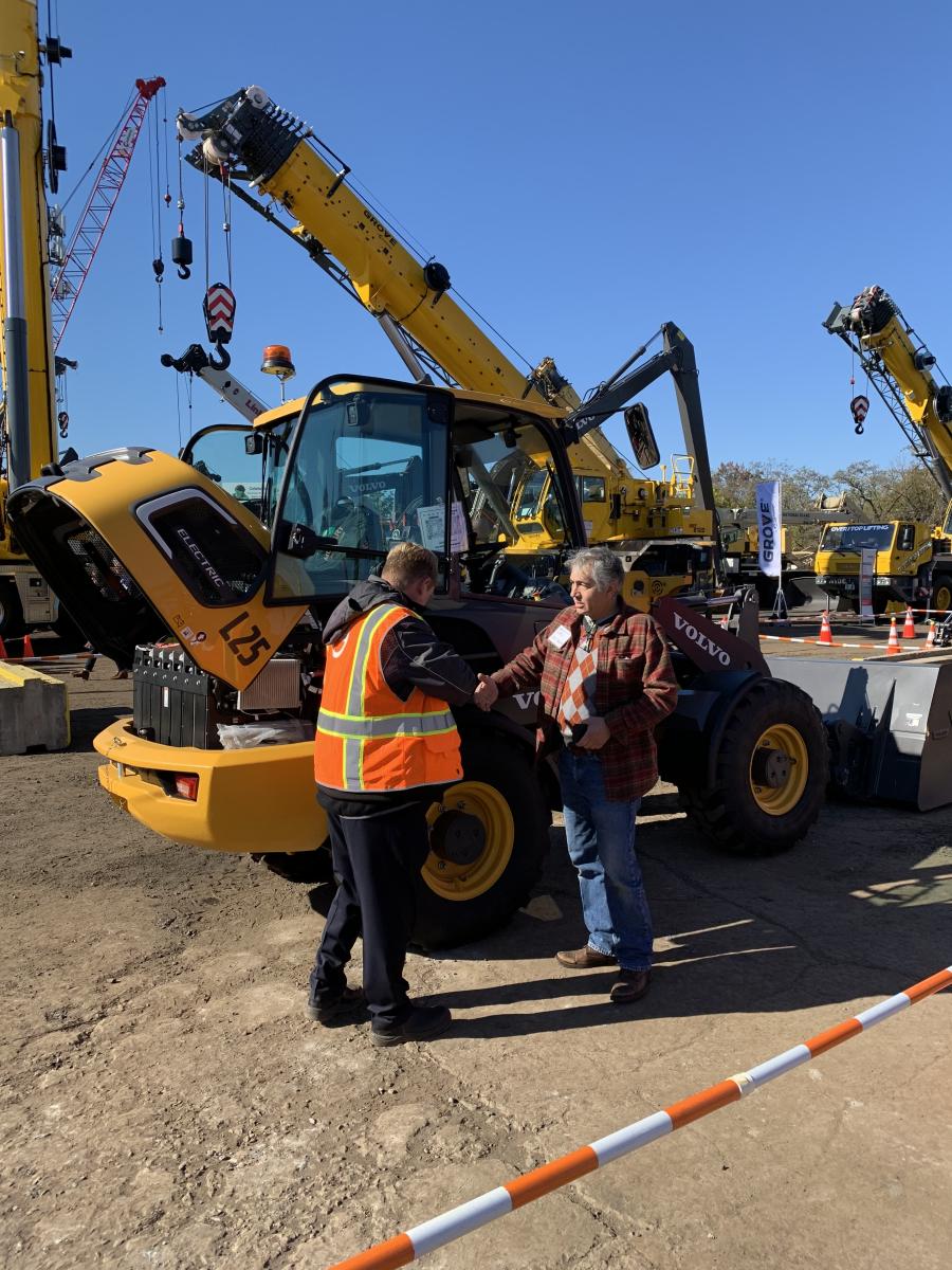 Hoffman Equipment employees were on hand to help deliver customers the information they needed on machines, like this member of EAJ Machinery (R), who was interested in the Volvo L25 electric wheel loader.