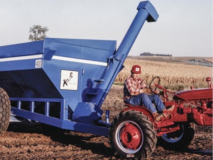 Kinze founder Jon Kinzenbaw pulls Kinze's first grain cart, the 400 model, in this photo from the 1970s. (Kinze Manufacturing photo)