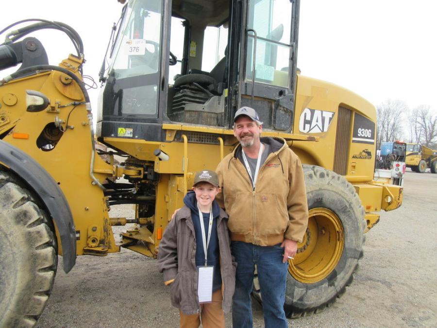 Jason Douglas (R) of Jason Douglas Excavating recruited his grandson, Laine Bronaugh, to review the machines in the equipment yard.