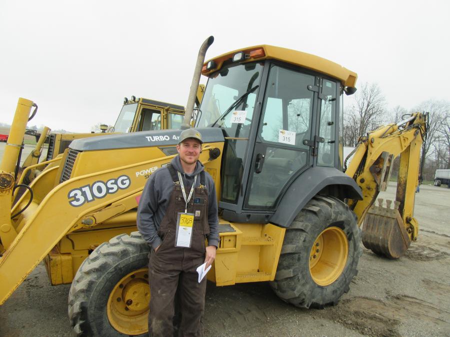 Jeremy Knoll of A1 Equipment looks over this John Deere 310SG backhoe.
