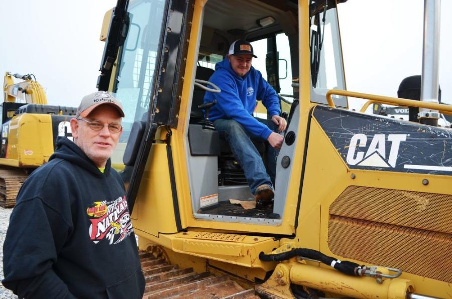 Getting ready to crank up a Cat D5G dozer for quick inspection are Mitchell Browning (L) and Justin Crawford of B&B Specialized Hauling, Buchanan, Ga. 