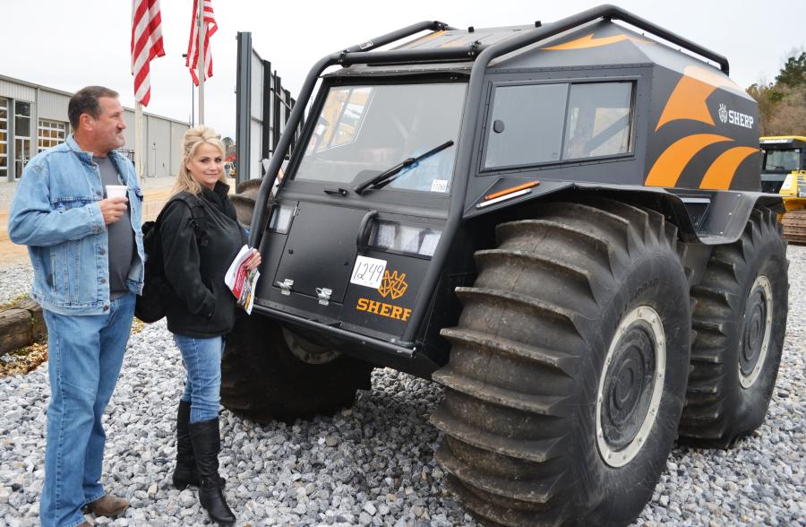 Admiring a rather unique piece in the auction, a SHERP ATV — considered to be the ultimate all-terrain vehicle — are Joey Guillot and his wife, Dione, of J&D Logging, Dupont, La. 
