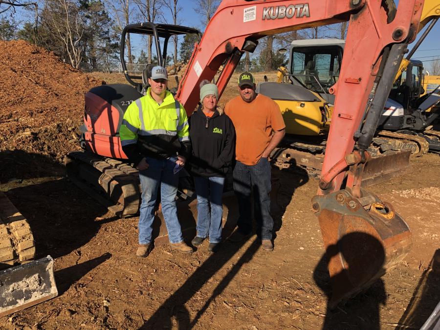 (L-R): The smaller excavators caught the attention of Austin, Sherry and Matt Rorrer, all of SLR Enterprises in Stuart, Va.
