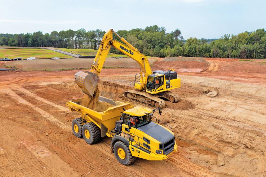 An operator loads material into the bed of a 45-ton haul truck using a Komatsu PC490LC-11 excavator at Paragon Site Solutions LLC’s Bretagne job site