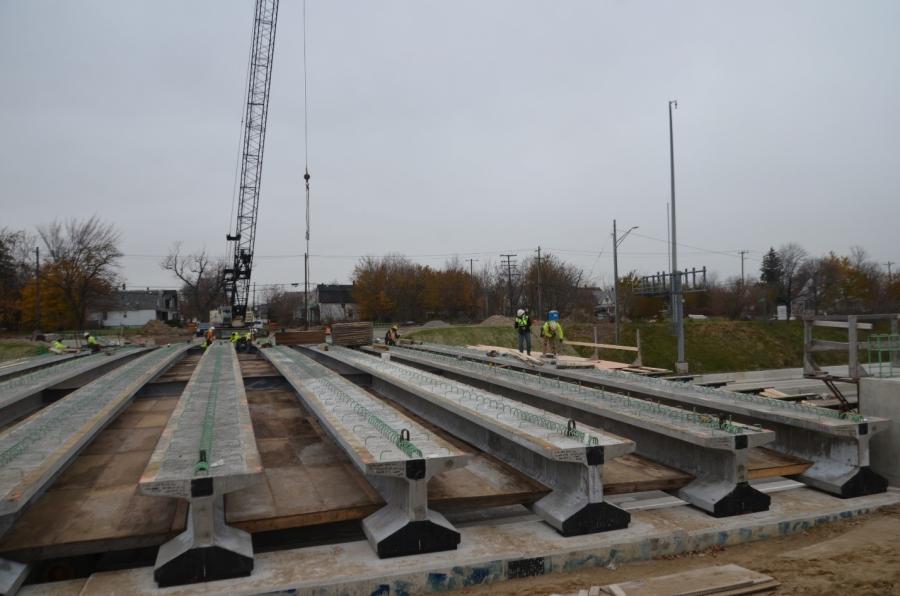 These concrete beams were set in late November as part of the I-94 modernization project in Detroit. The beams on the Burns Road bridge over I-94 are reinforced with carbon fiber composite strands, providing greater strength than steel without deterioration from corrosion. The technology is considered a game-changer for bridge building. 
(MDOT photo)