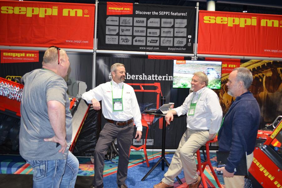 Discussing the products available from Seppi M USA (L-R) are David Kopp, FMI Equipment, Spokane, Wash.; Seppi M’s Ben Carlson and Dan Phillips; and Donald Wiseman, WTD Equipment, Portland, Ore. 
