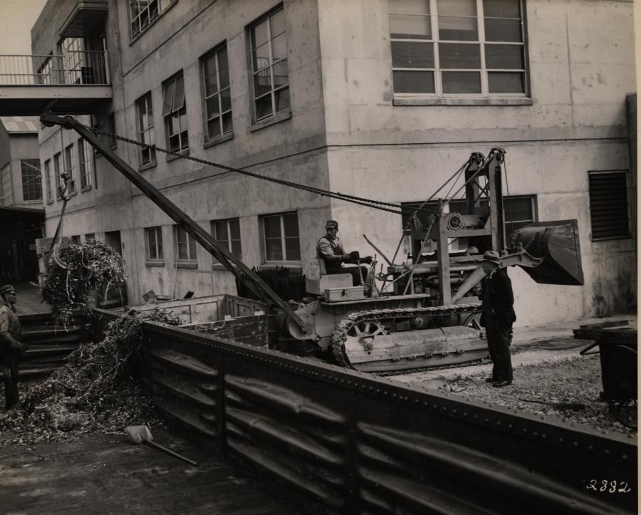 This Cat D4 is equipped with a Trackson cable loader, a Hyster winch and a crane boom fabricated by owner Federated Metals in San Francisco, Calif. The loader gathered bulk scrap from stockpiles, and the crane – using a large hook in this 1942 image – loaded it into gondola cars. 
(Hyster Company image/HCEA)