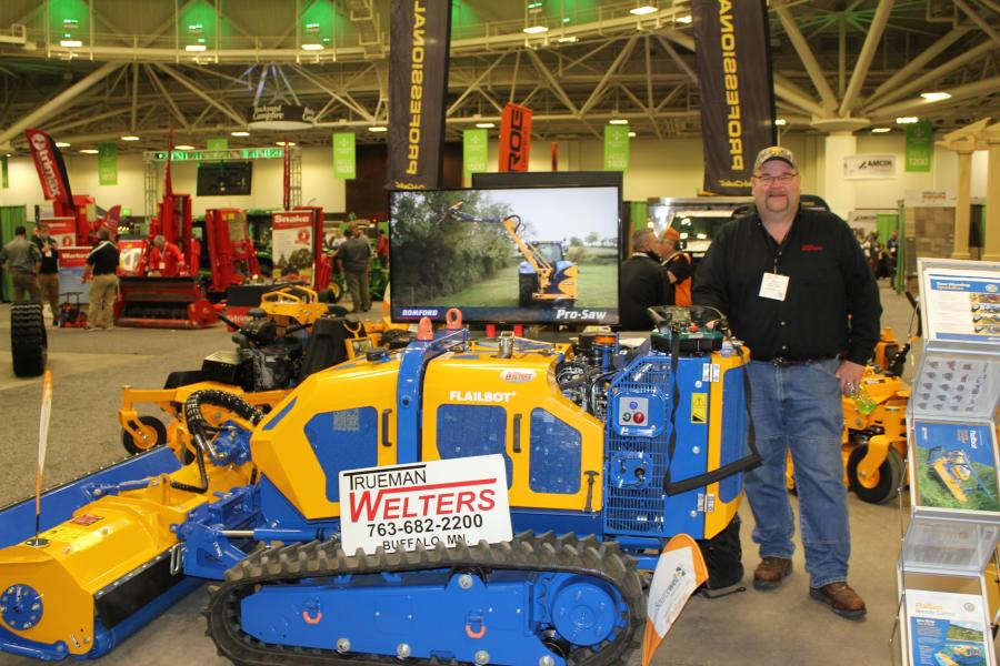 Steve “Cooter” Erickson, sales of Trueman Welters, Buffalo, Minn., with a new Bomford compact Flailbot mowing remote control unit. 

