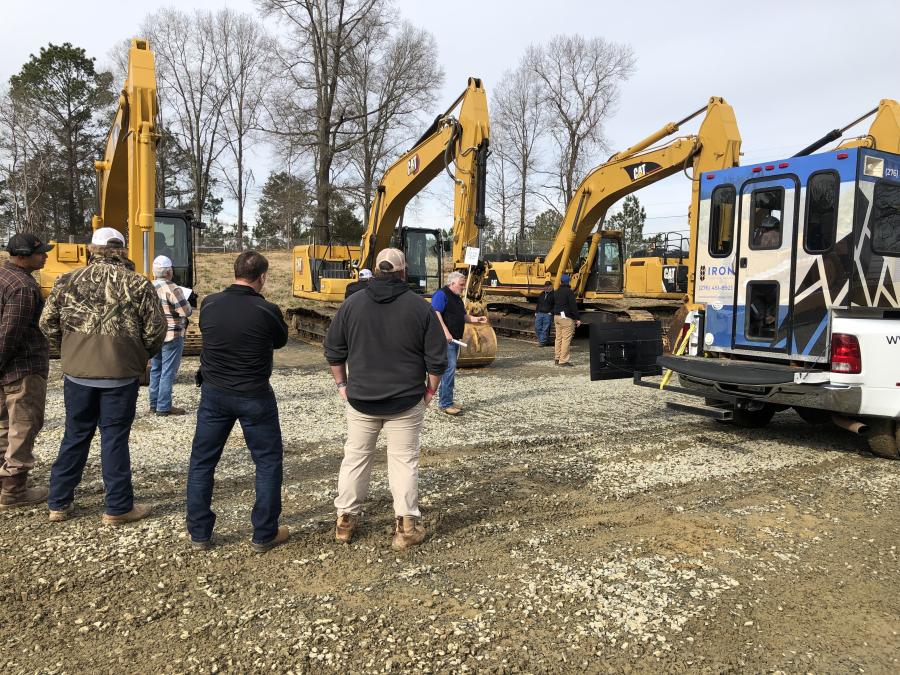Cat excavators are being auctioned off.
