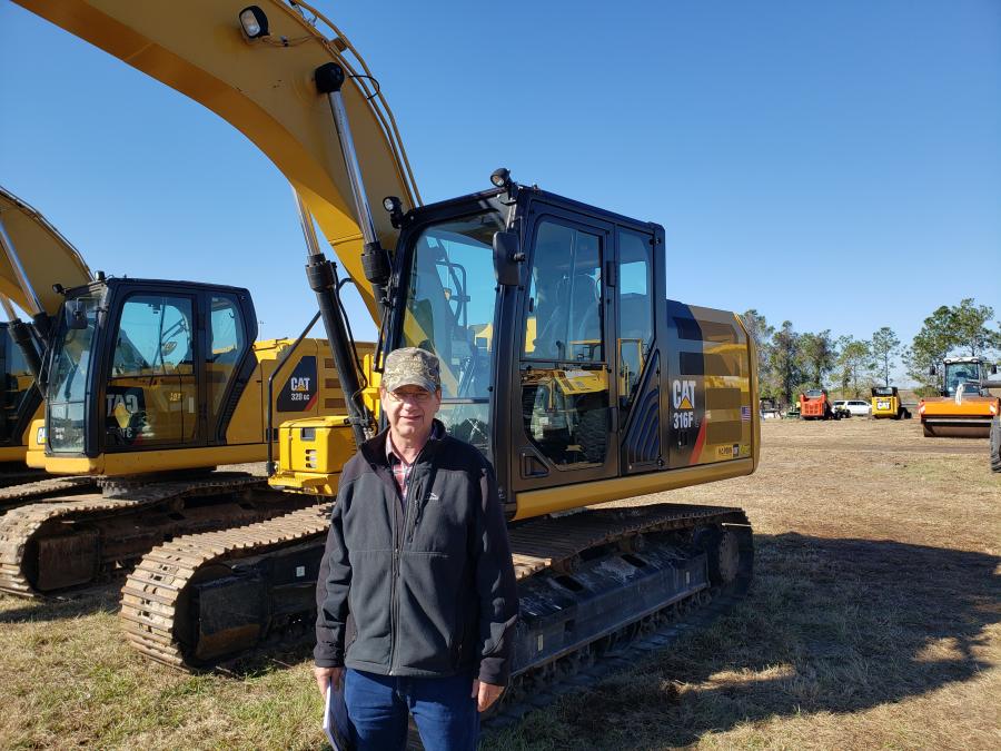 Curt French, owner and president of Central Wisconsin Equipment Company in Marion, Wis., looks over this Cat 316F L excavator at the Alex Lyon & Son auction in Bushnell, Fla.