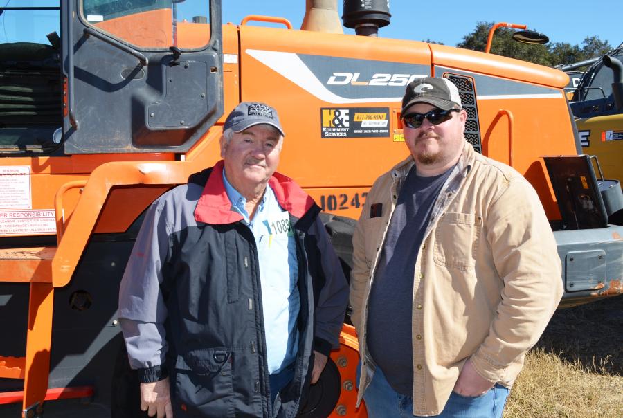 Looking over some of the loaders of interest, including this Doosan DL 250, are David Raper (L) of Sons Construction, Madisonville, Tenn., and Jordan Raper of Sons Construction/Sweetwater Machine Shop, Madisonville, Tenn.