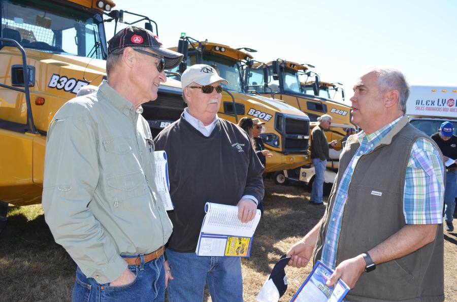 Discussing some machines of interest that are about to be auctioned (L-R) are Rick Newman and Herb Cress of Newman Tractor, Verona, Ky., and Henry Meinhardt, Brandywine Trucks & Equipment, Brandywine, Md.