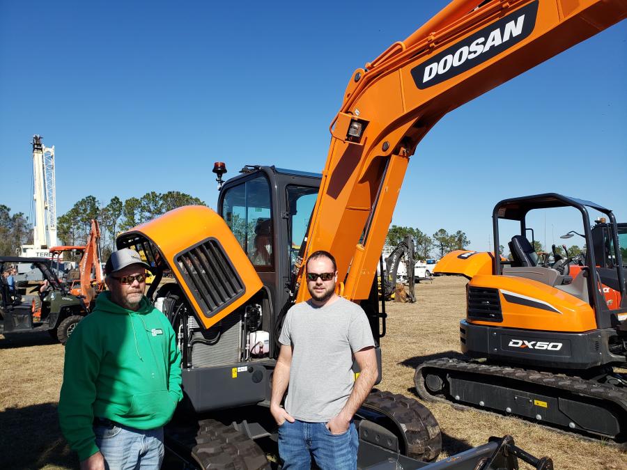 Dwayne (L) and Nate Heifner of Push and Shove Excavating in Utica, Ky., look under the hood of this Doosan DX62R excavator.