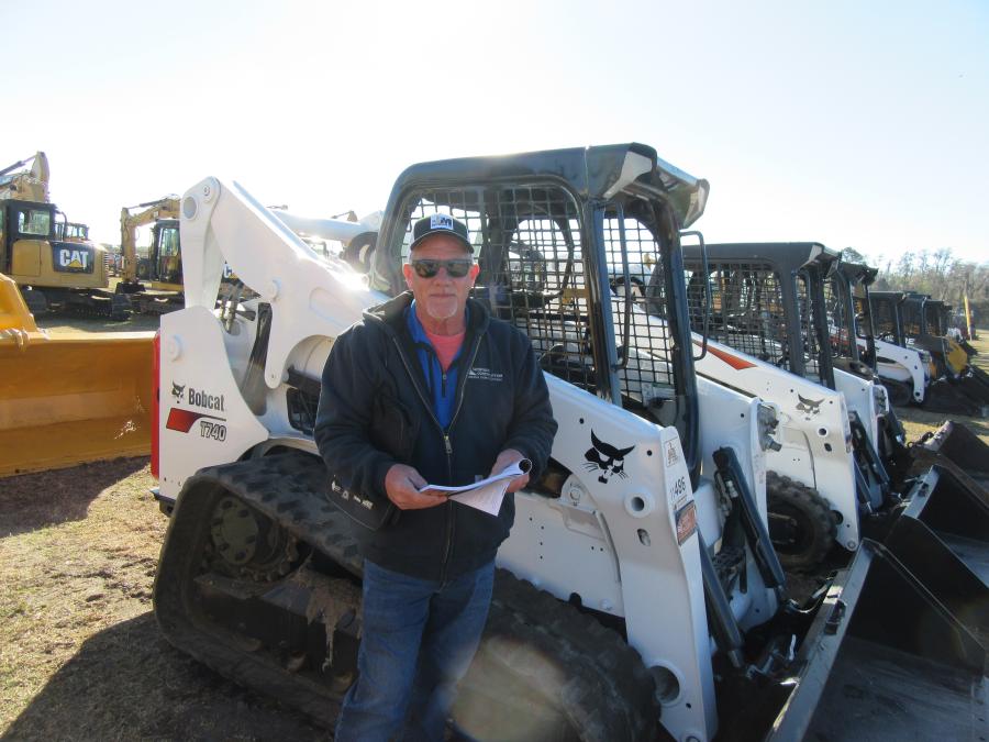 Dave Swingler of Swingler Construction looks over the skid steer loaders at the Jeff Martin auction.