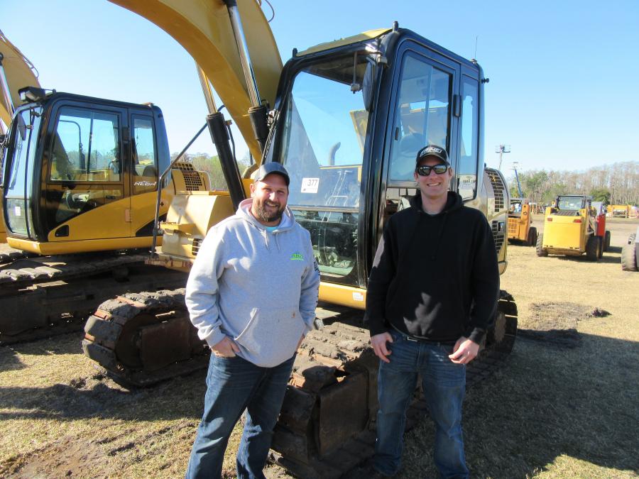 In from Holland, Mich., Jon Brewer (L) of BS&G Recycling and Kyle Prince of Landscape Design Services consider a bid on this Cat 311D excavator.