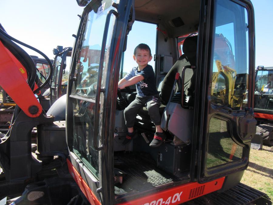 Three-year-old operator in training Braden Purrier of MS Audet Wrecking & Excavating, based in Connecticut, tries his hand with this Kubota KX080-4 compact excavator at the auction. 