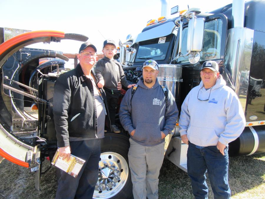 (L-R): Stacy Elkins, with grandson Layton and son Kyle of Kyle Elkins Hauling, joined Mark Ray of Mark-It Trucking to review the wide selection of trucks at the auction.