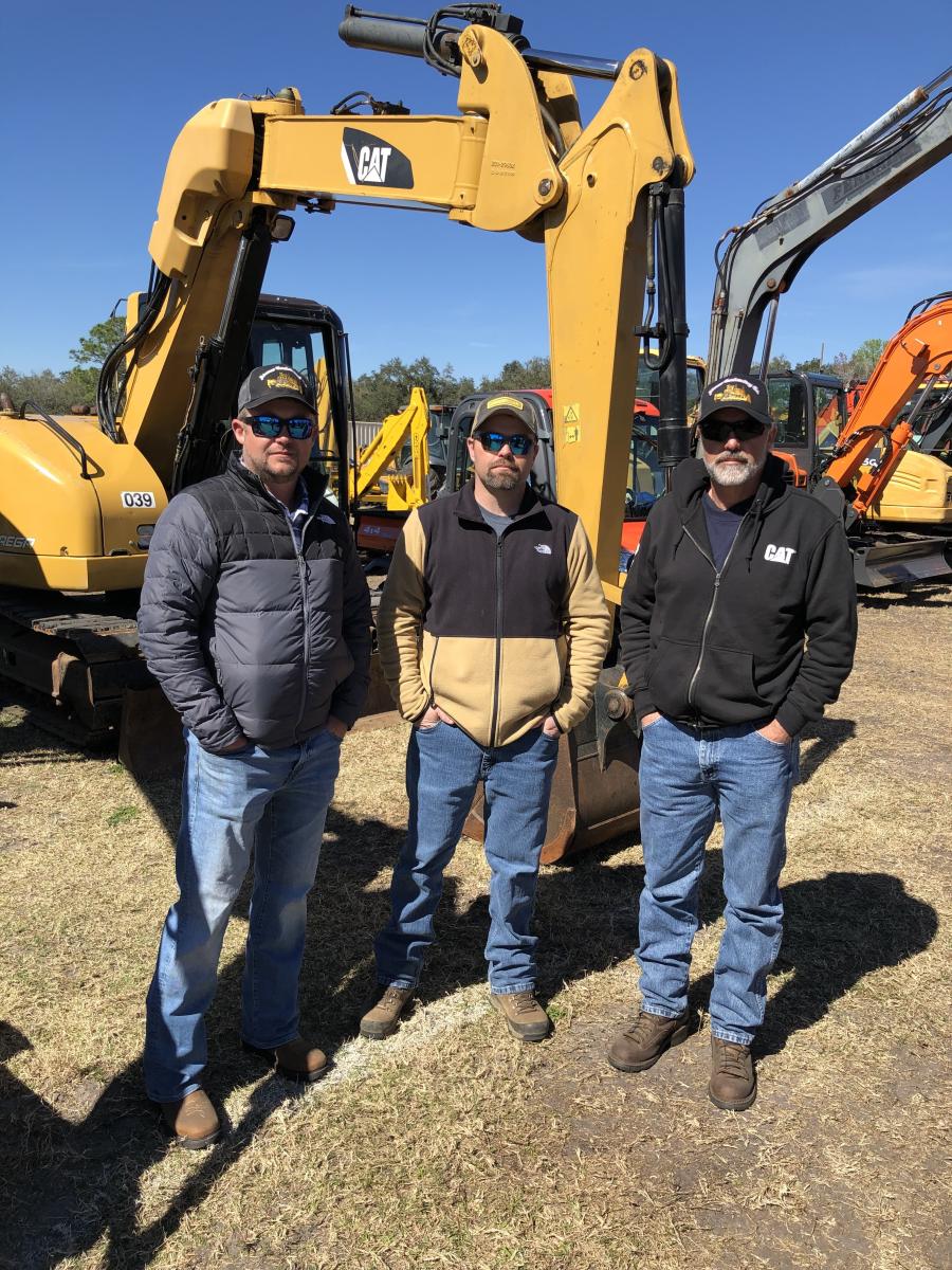 Interested in the wide assortment of excavators (L-R) are Jesse Adams, Adams Contracting in Robbinsville, N.C.; and Willard and Dalton Adams, both of Robbinsville Pallet Company.