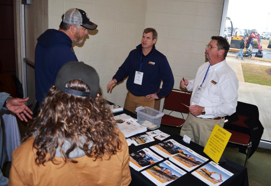 Border Equipment’s Brad Nuss (C) and Chuck Abney (R) talk with a group of public works professionals about their Case product offerings. 