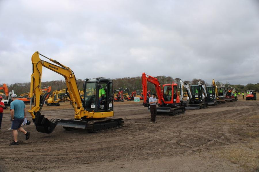A line of mini-excavators heads into the ring and on to new homes.
