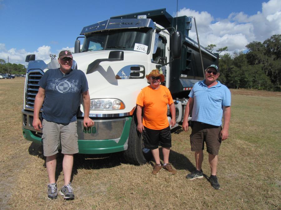 (L-R): Dave Innes, Ronald Trombley and Todd Wendorf of Michigan’s Astec Asphalt consider a bid on this Mack truck.