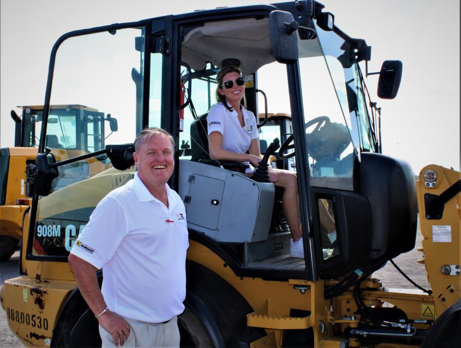Rob Williams of Richmond Va., took the opportunity to give an operating lesson on a Cat 908M to Katie Husband, Fort Lauderdale, Fla. Both are part of International Construction Equipment.