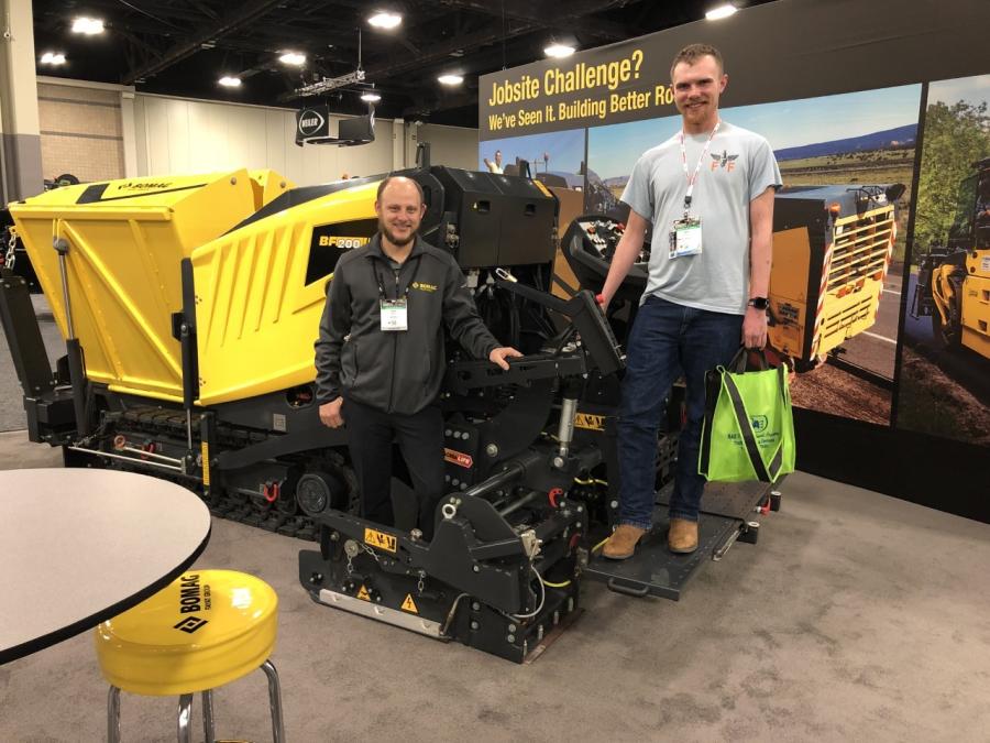 Andy Banas (L) of Bomag and Zach Layman of Smith & Son Seal Coating & Stripping in Dayton, Ohio, look at the BF200 paver Bomag had on display.