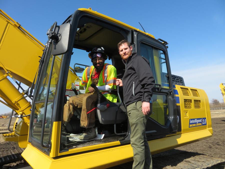 Operator Jesiah Lee of C. Lee Construction Services in Gary, Ind., goes over some instructions with Roland Machinery’s Zac Lucas, technology solutions expert.

