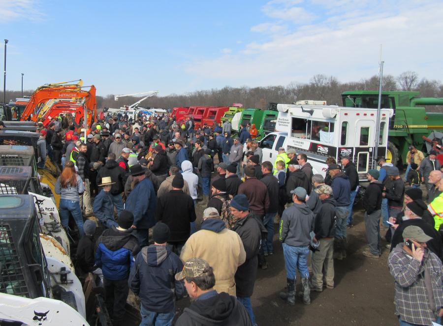 Crowds gather to bid on the large selection of construction equipment.

