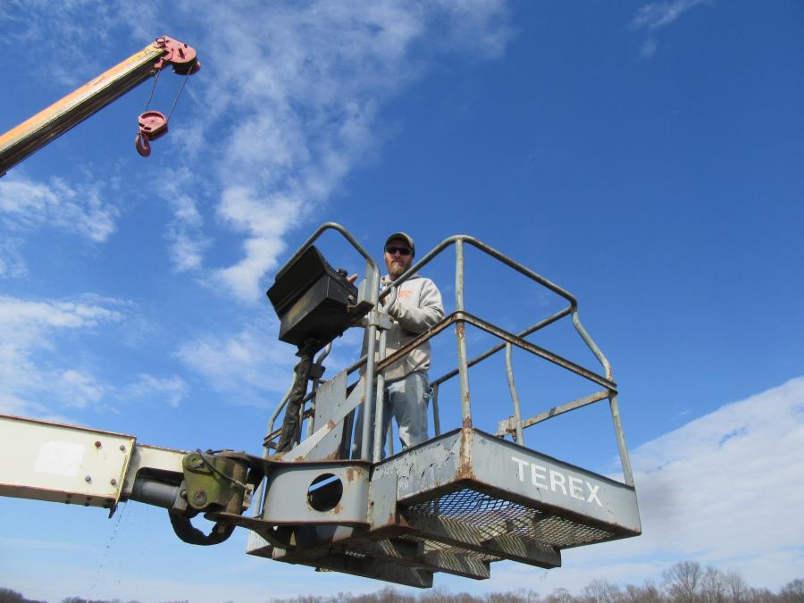 Chris Fussner of Fussner Builders gets a bird's-eye view of the auction activities from this Terex TB42 aerial lift.

