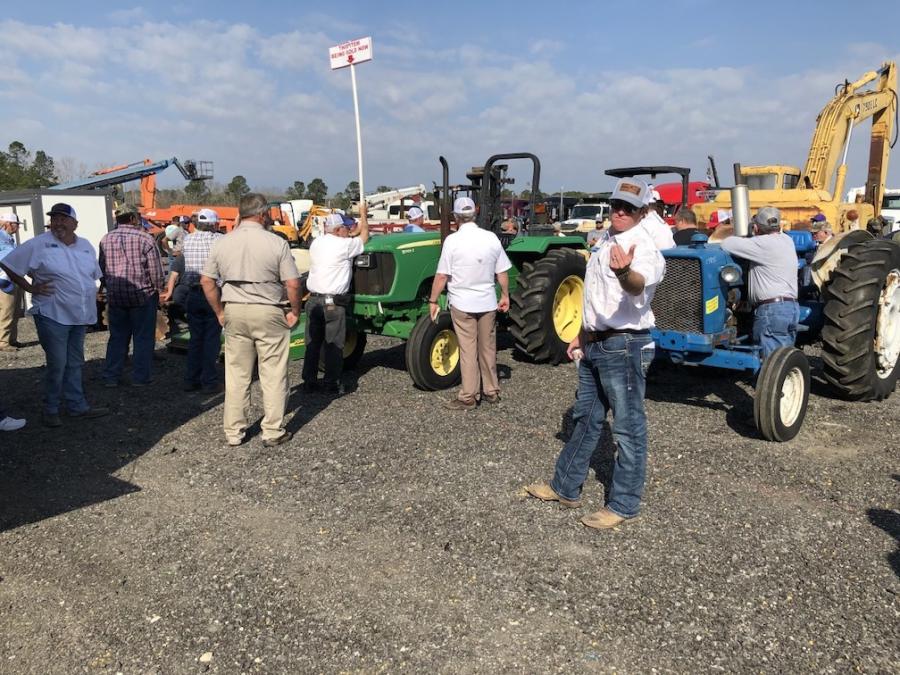 Matt Warren catches the high bid on the John Deere 5065E farm tractor.