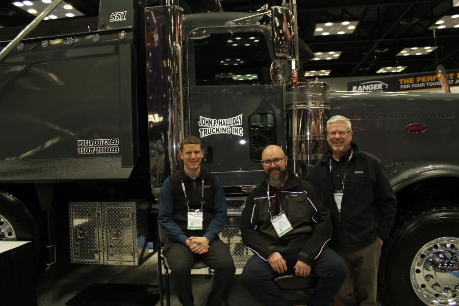 The crew of Cleveland Brothers Equipment Co. in Harrisburg, Pa., (L-R) are Brandon Fritz, Jesse Bridge and Greg Kohli with one of the trucks sold to John P. Halliday Trucking Inc. 